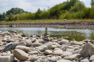 Amazing round stone near a flowing river, Stones are perfectly balanced on one another and forming, These are river stones, or also buddha stones