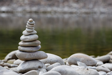 Amazing round stone near a flowing river, Stones are perfectly balanced on one another and forming, These are river stones, or also buddha stones