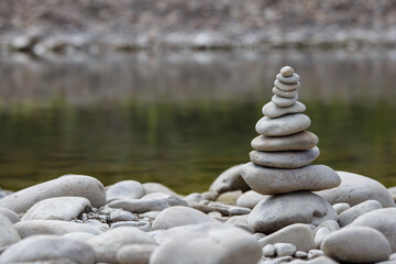 Amazing round stone near a flowing river, Stones are perfectly balanced on one another and forming, These are river stones, or also buddha stones