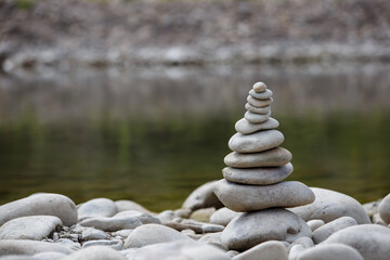 Amazing round stone near a flowing river, Stones are perfectly balanced on one another and forming, These are river stones, or also buddha stones