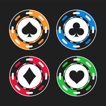 Four vibrant color poker chips adorned with the suits of playing cards spades, diamonds, clubs, and hearts isolated on dark background. Chips feature classic design, play in games like poker blackjack