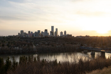 Fototapeta na wymiar Cityscape on the River by Sunset