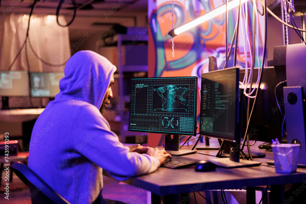 Poster african american hacker in hood breaking into server and stealing sensitive information. internet cr