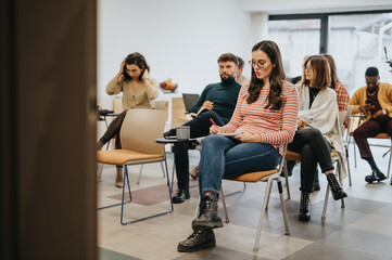 Diverse group of people attending a workshop or business seminar indoors.