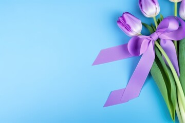 A top view of purple tulips adorned with a purple ribbon on a calming blue background. Purple Tulips with Ribbon on Blue Background Flat Lay