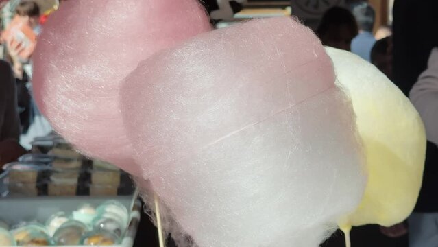 Making cotton candy or candy floss in street food market.
