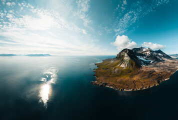 drone shot for breathtaking footage of wild nature in svalbard, majestic mountains in the clouds,...