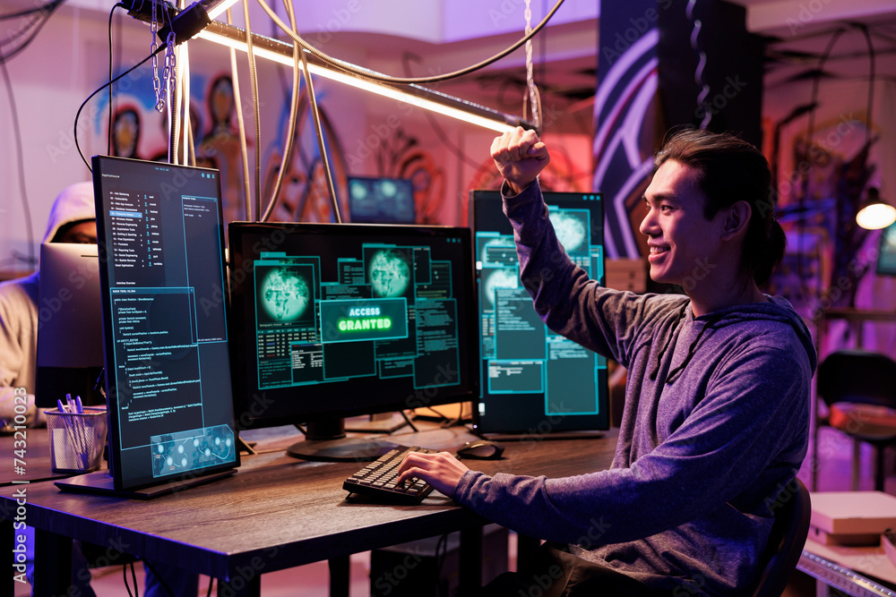 Poster hacker celebrating system successful hacking with cheerful smile and winner gesture. asian criminal 
