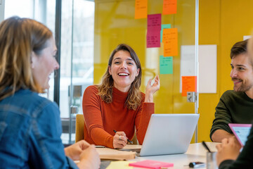 Group of People Sitting Around a Table With a Laptop. Generative AI.