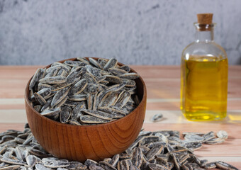 Close-up of sunflower seeds with their oil in the background. Healthy taste.