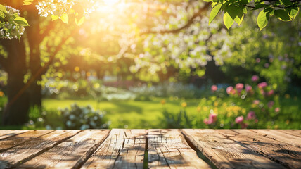 Empty spring table for copy space with trees in blooming and defocused sunny garden
