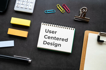 There is notebook with the word User Centered Design. It is as an eye-catching image.