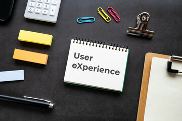 There is notebook with the word User eXperience. It is as an eye-catching image.