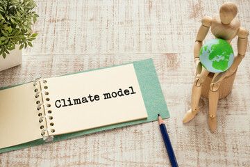 There is notebook with the word Climate model. It is as an eye-catching image.