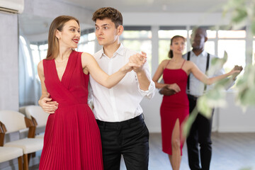 During rehearsal of reporting concert, young man and woman participants of dance workshop perform...