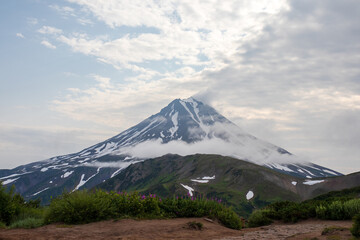 View of the volcano. Travel and tourism on the Kamchatka Peninsula. Beautiful nature of Siberia and the Russian Far East. Vilyuchinsky Volcano (Vilyuchinskaya Sopka), Kamchatka Territory, Russia.
