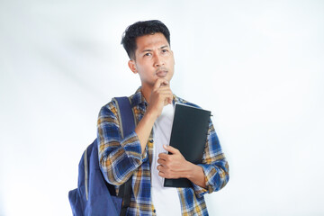 Portrait of pensive young Asian man student wearing shirt with backpack holding notebook and...