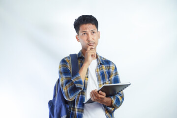 Concentrated young Asian students with backpacks holding notebooks and thinking about something isolated on white background. Education in high school university college concept