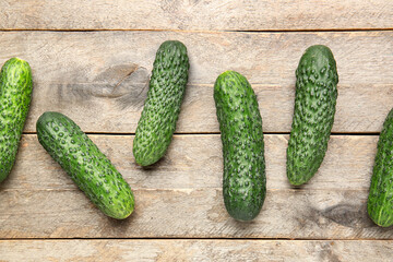 Fresh cucumbers on wooden background