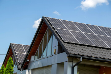 Fototapeta premium House roof with photovoltaic modules.