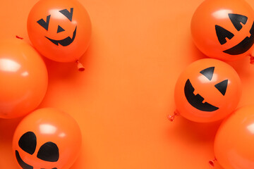 Funny Halloween orange balloons on color background