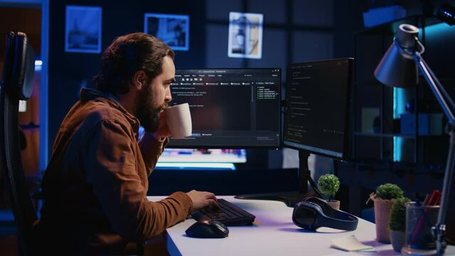 Stressed engineer feeling pressed by deadline, thinking how to finish developing code on PC. IT specialist brainstorming ways of solving database errors, working hard, drinking coffee, camera B