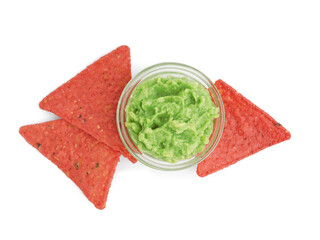 Red nachos and tasty guacamole on white background