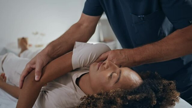 Manual chiropractor treat patient in clinic. Closeup woman visit physiotherapy