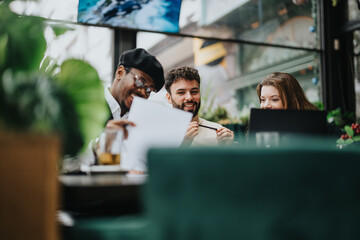 Three multiethnic colleagues collaborating over paperwork in a relaxed restaurant environment, with a focus on teamwork and business strategy.