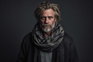 Portrait of an old man with a gray beard and a shawl.