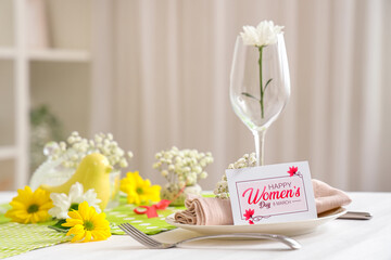Simple table setting with beautiful flowers for International Women's Day celebration