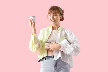 Female artist with paint cans on pink background