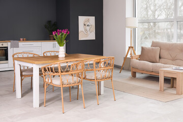 Beautiful interior of living room with dining table and tulips