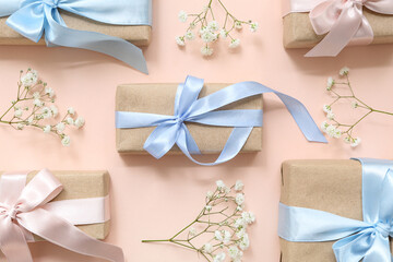 Festive composition with wrapped gift boxes and spring flowers on beige background