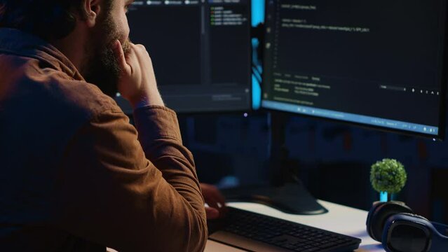 Computer engineer deliberating ways of fixing errors while developing code on PC. IT professional brainstorming ways of solving database errors, remotely working from home, camera A