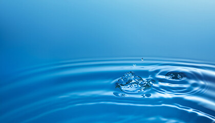 Naklejka na ściany i meble Close up of water with waves and ripples and copy space on blue background. Water, shape, liquid and colour concept.