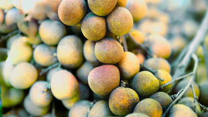 Fresh longans on the fruit stand in the fresh market