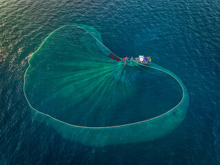 Drone view a fishing boat is netting anchovies on Nha Trang sea - Nha Trang city, Khanh Hoa province, central Vietnam