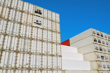 Shipping containers stacked high at a distribution warehouse
