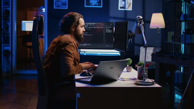 Developer pressed by deadline, drinking coffee and doing multitasking to finish developing PC code. Caffeinated IT specialist solving database error using multiple desktop and laptop screens, camera B
