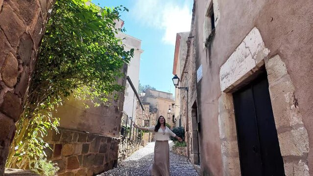 Happy woman dancing in Tossa de Mar