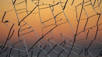 Sunset gradient through cracked glass