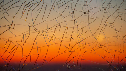 Sunset gradient through cracked glass