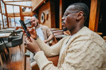 Multicultural business executives meet in an urban coffee bar to discuss growth strategies and financial planning.