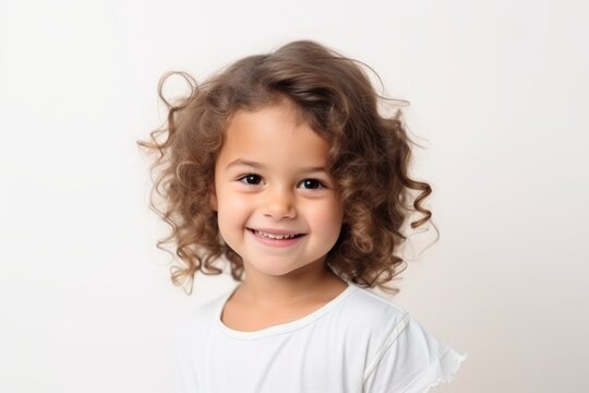 Portrait of a happy little girl with curly hair over white background