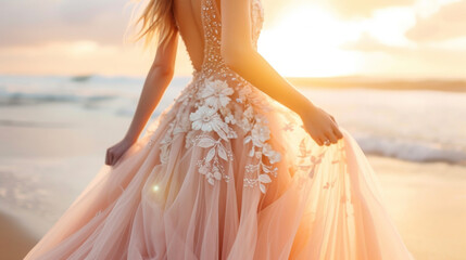 Fototapeta na wymiar A romantic and whimsical bride in a blush pink tulle dress with a beautifully beaded bodice and delicate floral appliques. Against a dreamy beach sunset her bridal look embodies