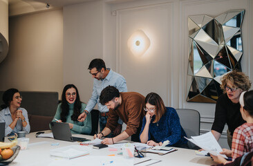 Multiethnic business teammates engaging in creative discussion at modern office desk. People working together with their senior mentors on a new project at modern office. Business indoors concept.