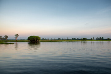 A tranquil billabong in Outback Australia, yet lurking within may hide saltwater crocodiles,...