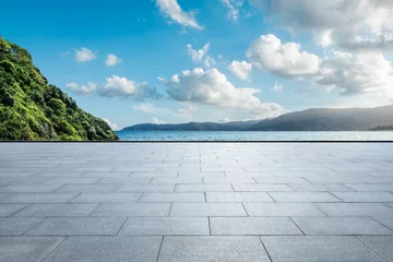 Raamstickers Empty square floor and green mountain with blue lake natural landscape under blue sky © ABCDstock
