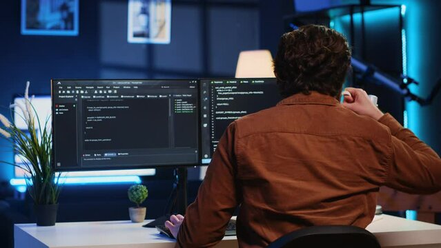Admin using javascript coding language to fortify security and safeguard consumer data, remotely working for IT company. Software developer upgrading binary code scripts on computer terminal, camera A